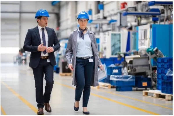 A man and a woman on a factory floor